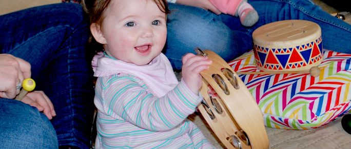 happy-baby-holding-tamborine-music-therapy-session