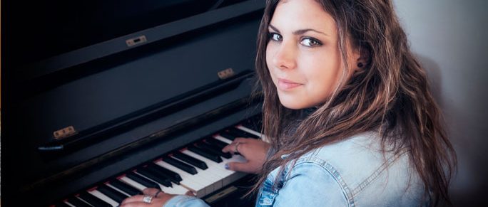 moody-teenage-girl-with-emotional-difficulties-at-piano-music-therapy